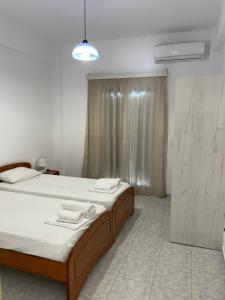 Postel nebo postele na pokoji v ubytování NAFSIKA Apartments