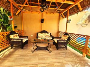 a patio with a table and chairs on a porch at Safi House in Boma la Ngombe