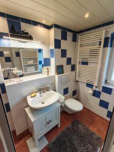 a bathroom with a white sink and a toilet at Das Edelweiß Apartment by ALA Living - stilvoll Urlauben mit traumhaftem Ausblick, Sonnenterrasse, 200m zur Zugspitzbahn! in Grainau