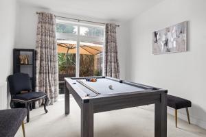 a room with a pool table and a window at Cozy Willow-Hot Tub, Sleeps9, FreeParking, Netflix in Birmingham