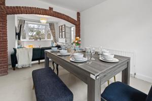 a dining room with a wooden table and chairs at Cozy Willow-Hot Tub, Sleeps9, FreeParking, Netflix in Birmingham