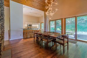 a dining room with a wooden table and chairs at Stratton Mountain Ski House Hot Tub Sauna Shuttle in Stratton Mountain