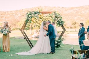 a bride and groom kissing at their wedding ceremony at San Vicente Golf Resort in Ramona +38 photos