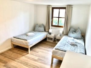 a bedroom with two beds and a window at Vilstal Apartments in Reisbach +13 photos