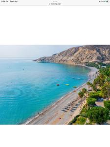 an aerial view of a beach with boats in the water at Katikies Grand - Superior Villa Adults Only in Pissouri