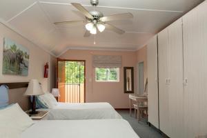 a bedroom with two beds and a ceiling fan at York House Guest House in Hillcrest