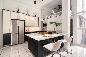 a kitchen with a large island with white countertops at Spanish Penthouse Historic Mansion Private Patio in San Juan