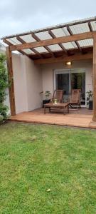a patio with two chairs and a bench on a deck at Casa Laprida in Mar del Plata