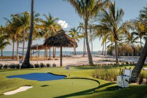 a golf course at the beach with palm trees at Islander Resort in Islamorada