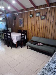 a living room with a table and a couch at Cabañas Gabella in Lago Ranco