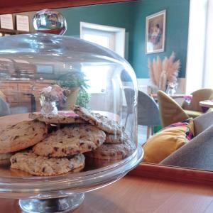 a stack of cookies in a glass dish on a table at Lucriolla in Champtoceaux +16 photos