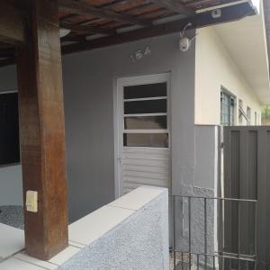 a front door of a house with a porch at Suite confortável no centro com Wi fi e TV a Cabo in Águas de São Pedro