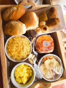 a box filled with different types of bread and pastries at Recanto dos Corais in Marau