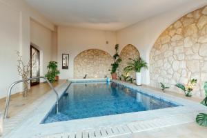 a pool in a house with a stone wall at mood house in Kos Town