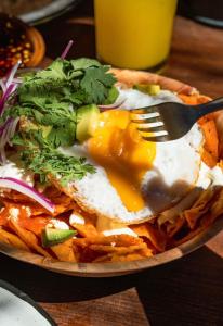 a plate of food with a fried egg and fries at Rancho Ecológico Sol De Mayo in Romerillal +14 photos