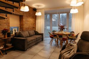 a living room with a couch and a table at Upene Home in Iecava