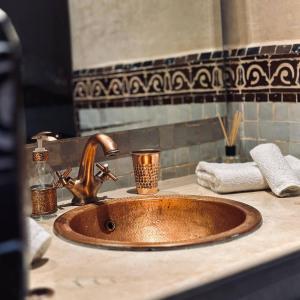 a sink in a bathroom with a copper sink at Private Riad Alemania in Marrakesh - Pool - Rooftop in Marrakech