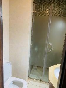 a bathroom with a shower with a toilet and a sink at sonu at Hostel in Dakar +8 photos
