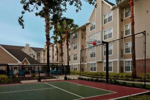 a tennis court in front of a building at Residence Inn by Marriott Orlando East/UCF Area in Orlando