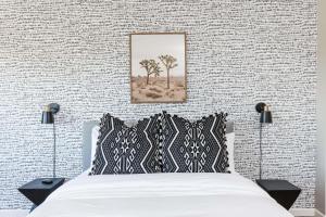 a bed with black and white pillows in a bedroom at Sereno - Sparkling Pool - Near Scottsdale Quarter in Phoenix +66 photos
