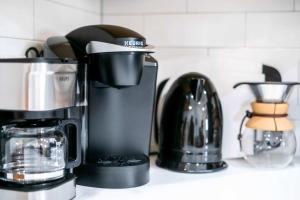 a coffeemaker and a coffee maker on a counter at Starlight Horizon 3 Cabins with Hot Tub Pet-Friendly Texas Hill Country Group Retreat Near Canyon Lake Pool, Stargazing, Sleeps 20 in Canyon Lake