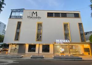 a large white building with a sign on it at Buendía Hotel in Barrancabermeja