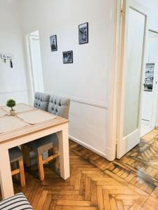 a dining room with a wooden table and a wooden floor at Buenos Ayres Apartment in Buenos Aires