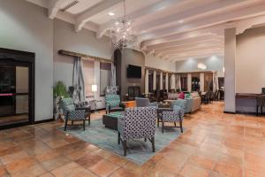 a lobby with chairs and tables and a living room at Residence Inn by Marriott Laredo Del Mar in Laredo