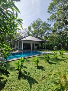 a house with a swimming pool in a yard at Villa Sukka in Tangalle