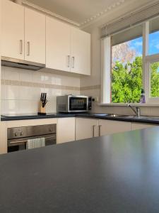 a kitchen with a counter top and a microwave at Red Robin Family Accommodation in Newstead +17 photos
