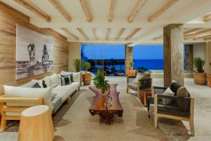 a living room with a couch and a table at Oceanfront Living & Surfing in Cabo Paradisiacal 2BR Condo in San José del Cabo