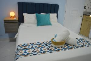 Postel nebo postele na pokoji v ubytování Apartamento Amueblado Caribe, Santo Domingo a 10 minutos del Aeropuerto Internacional de las Americas + 37 fotografií