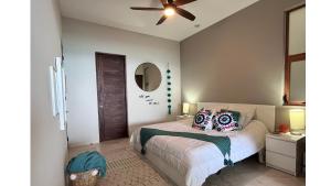 a bedroom with a bed and a ceiling fan at Oceanfront Living & Surfing in Cabo Paradisiacal 2BR Condo in San José del Cabo +16 photos