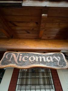 a sign hanging from the ceiling of a restaurant at NicoMay in Ciudad Lujan de Cuyo