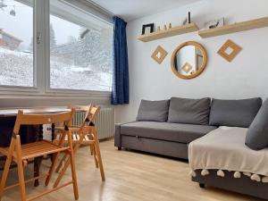 a living room with a couch and a table at Golden Luxe - Fronte pista Comprensorio di Campiglio in Marilleva