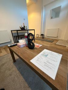 a table with a pair of scissors on top of it at Charming 3-Bedroom house in Cardiff
