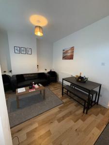 a living room with a couch and a table at Charming 3-Bedroom house in Cardiff