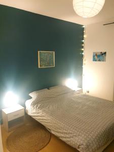 a bedroom with a bed and two night stands at Maison spacieuse face aux Pyrénées in Carla-Bayle