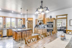 a kitchen with wooden cabinets and a table and chairs at Spacious Afton Home Patio, Grill and Mountain Views in Afton