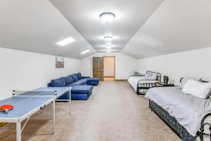 a living room with a ping pong table and a couch at Spacious Afton Home Patio, Grill and Mountain Views in Afton