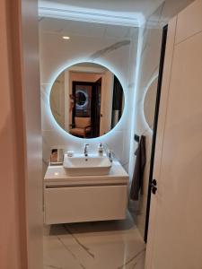 a bathroom with a sink and a mirror at Villa Efsa in Emin Sitesi