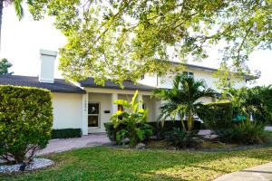 a white house with trees and plants at Grand Home Jacuzzi, Heated Pool, Games, BB Court L20 in Miami