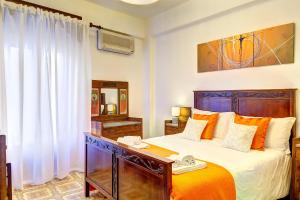 a bedroom with a large bed and a window at Naxos Holiday Apartment in Giardini Naxos