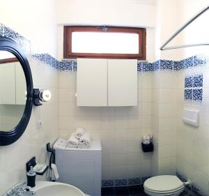 a bathroom with a toilet and a sink at Naxos Holiday Apartment in Giardini Naxos +27 photos