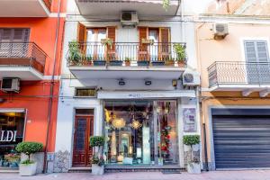 a store on a city street in front of a building at Naxos Holiday Apartment in Giardini Naxos