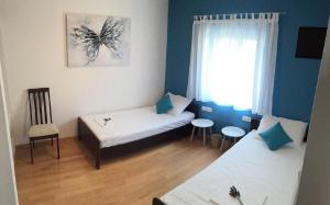 a small room with two beds and a window at Apartment Nikola M in Bol