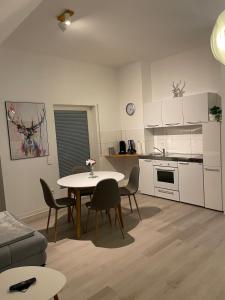 a kitchen and dining room with a table and chairs at Auszeit Offenburg in Offenburg +24 photos