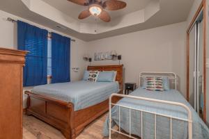 a bedroom with two beds and a ceiling fan at 2BR Village At Indian Point 604 near SDC-Free Tickets Daily up to $500 Value) in Branson +13 photos
