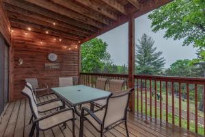 a wooden deck with a table and chairs on it at 2BR Village At Indian Point 604 near SDC-Free Tickets Daily up to $500 Value) in Branson