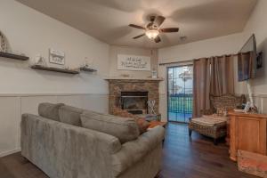a living room with a couch and a fireplace at 2BR Village At Indian Point 705 near SDC-Free Tickets Daily up to $500 Value in Branson